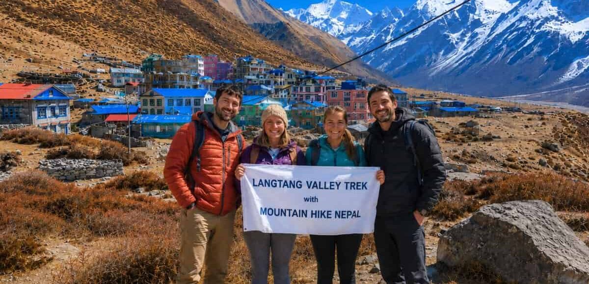 Trekkers holding Mountain Hike Nepal banner during Langtang Valley Trek near Kyanjin Gompa in Nepal