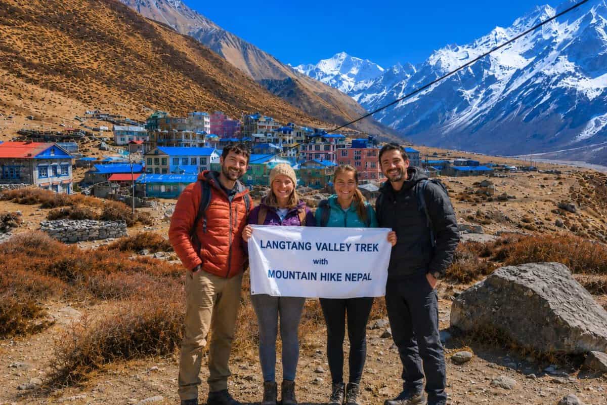 Trekkers holding Mountain Hike Nepal banner during Langtang Valley Trek near Kyanjin Gompa in Nepal