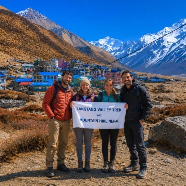 Trekkers holding Mountain Hike Nepal banner during Langtang Valley Trek near Kyanjin Gompa in Nepal