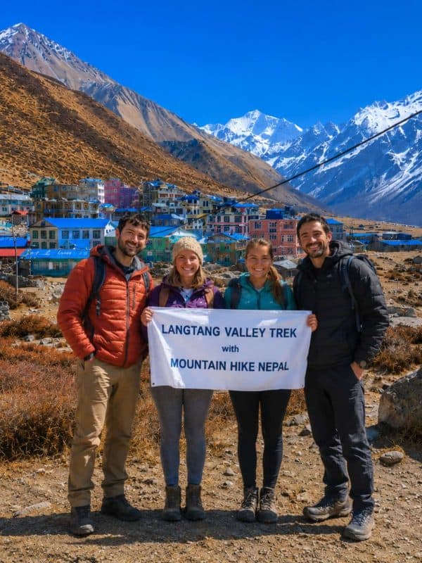 Trekkers holding Mountain Hike Nepal banner during Langtang Valley Trek near Kyanjin Gompa in Nepal