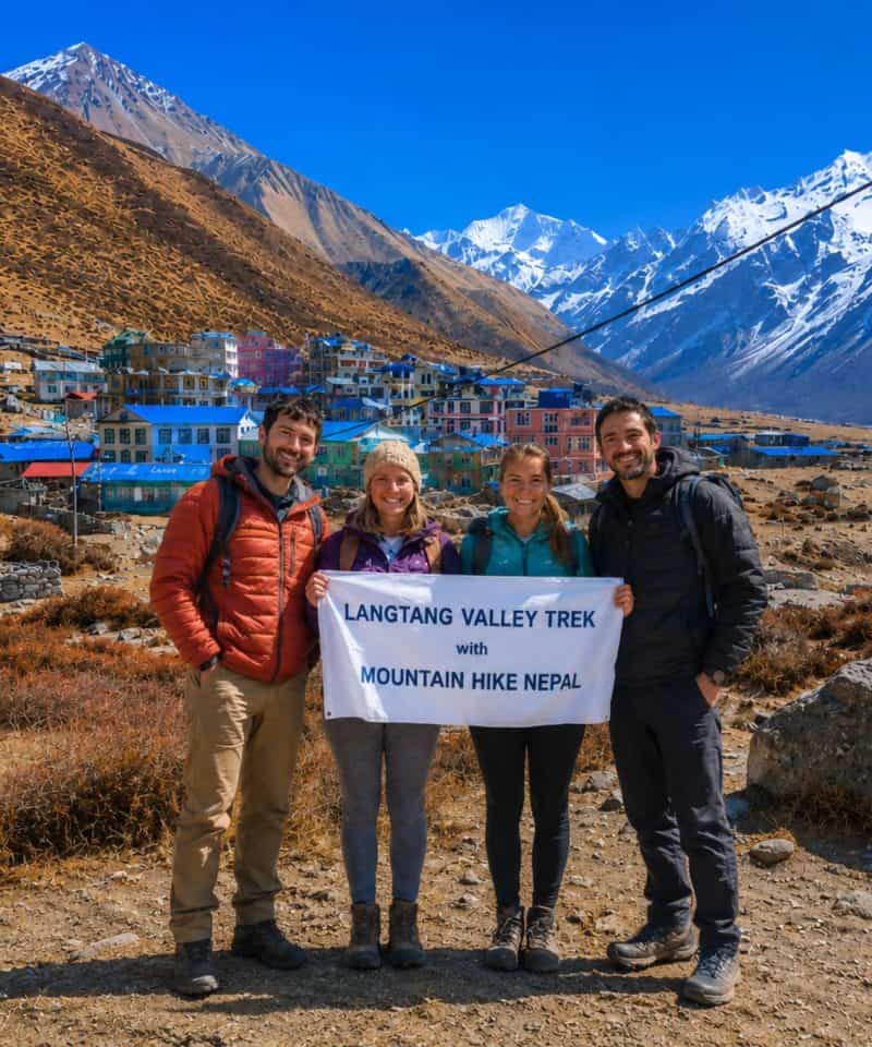 Trekkers holding Mountain Hike Nepal banner during Langtang Valley Trek near Kyanjin Gompa in Nepal