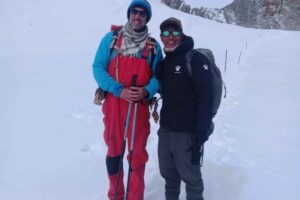 French Solo Trekker with Local Guide – Everest Three Passes Trek French solo trekker with a local guide on a snowy section of the Everest Three Passes Trek