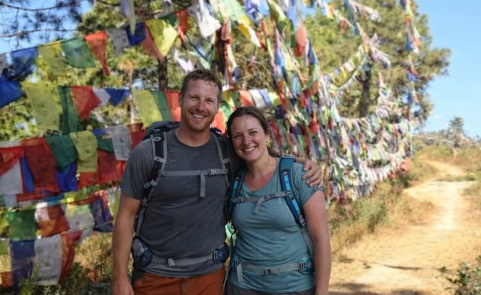 Hikers standing beside colorful prayer flags along the Champadevi Day Hike trail near Kathmandu