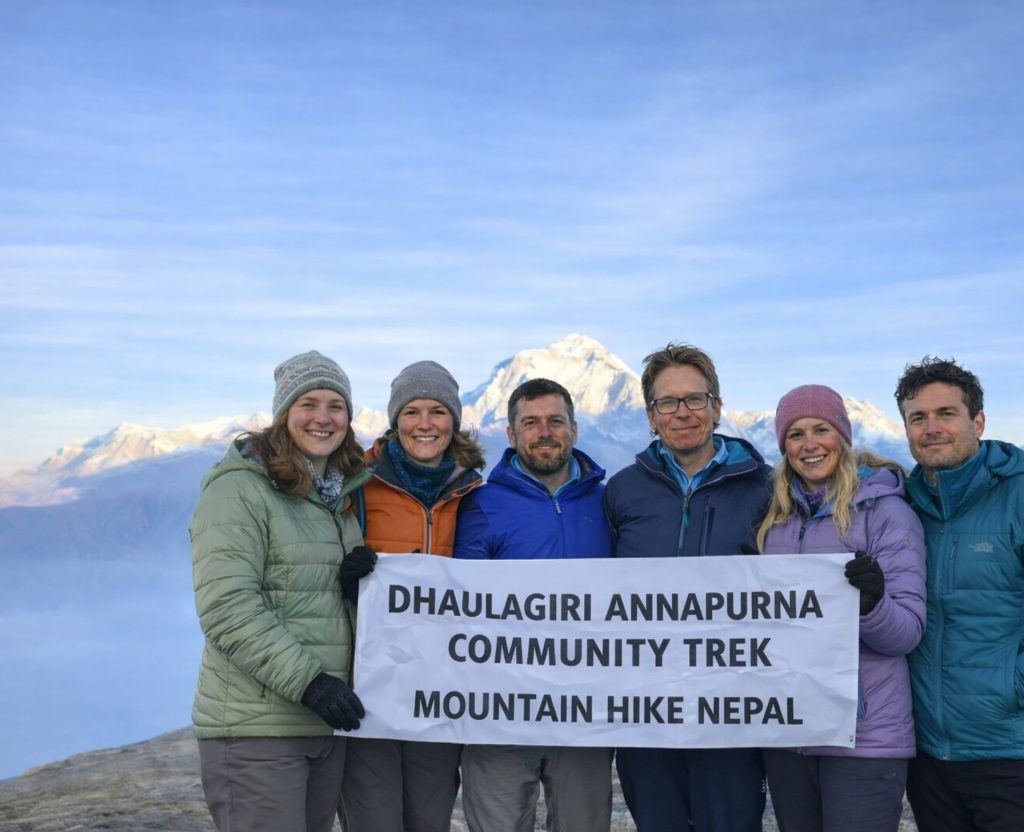 Trekkers holding a banner during the Dhaulagiri–Annapurna Community Trek in Nepal