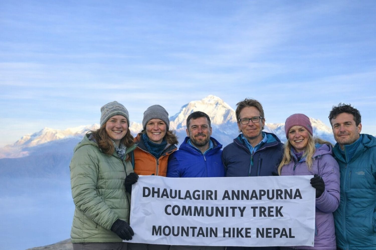 Trekkers holding a banner during the Dhaulagiri–Annapurna Community Trek in Nepal