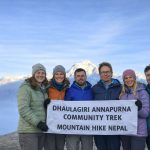 Trekkers holding a banner during the Dhaulagiri–Annapurna Community Trek in Nepal