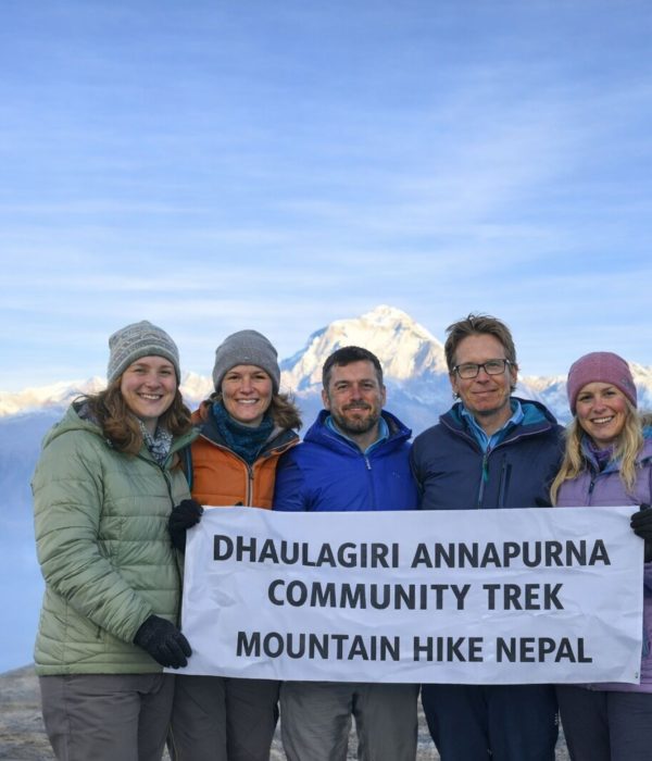 Trekkers holding a banner during the Dhaulagiri–Annapurna Community Trek in Nepal
