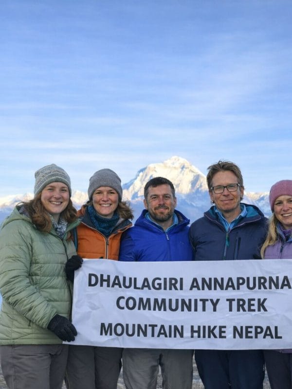 Trekkers holding a banner during the Dhaulagiri–Annapurna Community Trek in Nepal