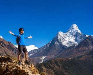 Everest Base Camp Trek in Nepal with Stunning Ama Dablam Views Trekker enjoying panoramic mountain views of Ama Dablam during the Everest Base Camp Trek in Nepal.