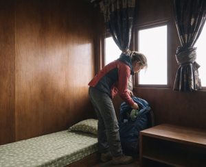 Trekkers packing bags inside a simple teahouse room on the Pikey Peak Trek