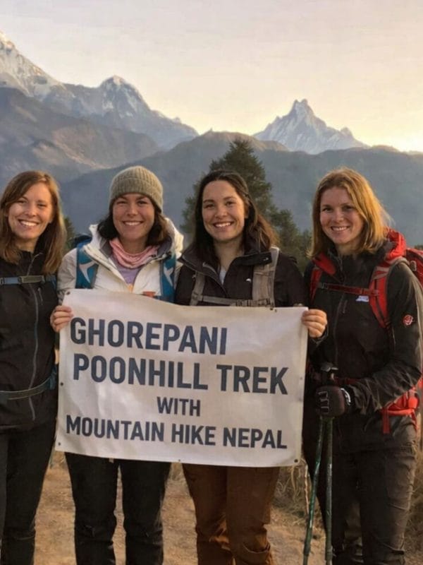 Group of trekkers at Poon Hill viewpoint on the Ghorepani Trek