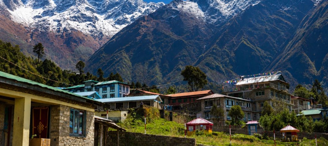 Mountain village and Himalayan peaks on the Everest Base Camp Trek by Road route
