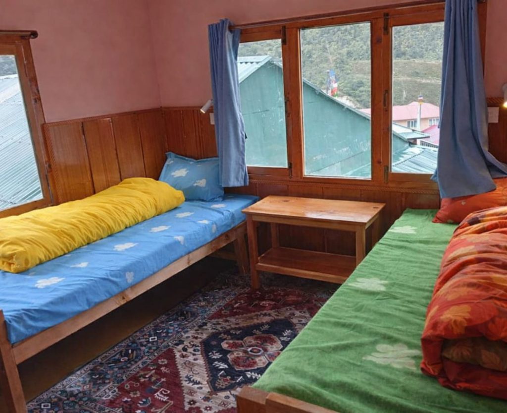 Trekkers resting in teahouse room during high altitude trek in Nepal Himalayas