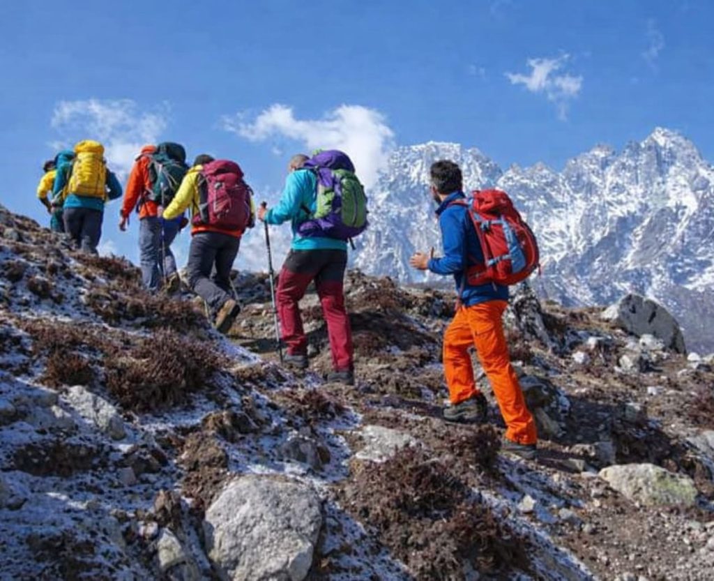 Trekkers hiking slowly during high altitude trekking in Nepal Himalayas