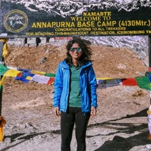 Trekker at Annapurna Base Camp Nepal with ABC signboard