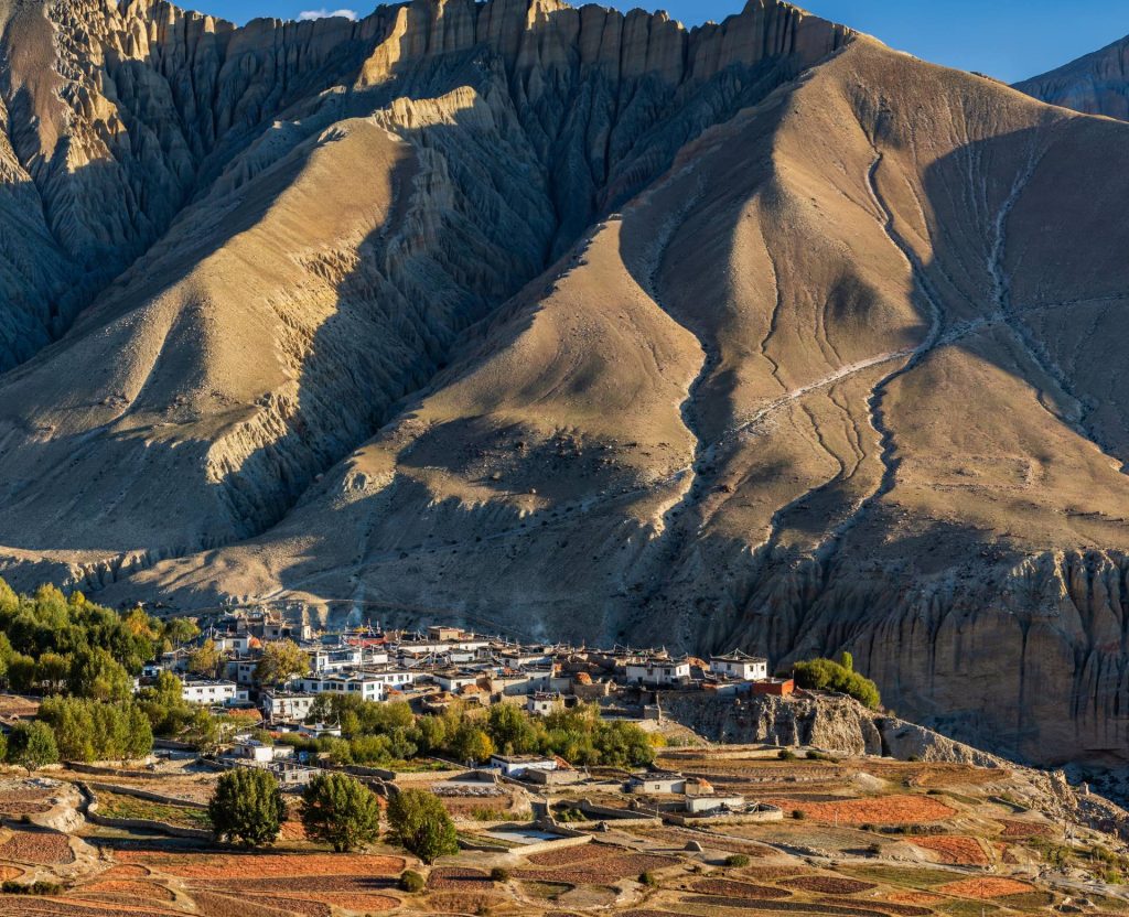 remote village with fields and mountains in Upper Mustang Nepal