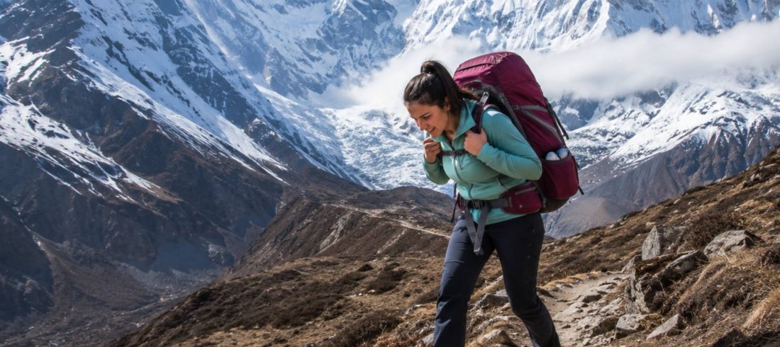 Annapurna Base Camp packing mistakes with female trekker carrying oversized backpack on Himalayan trail