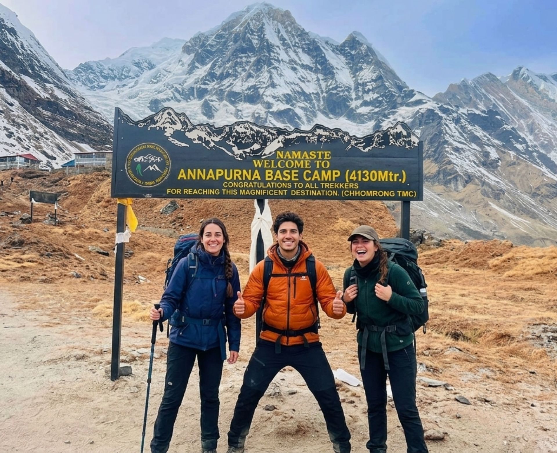 Trekkers posing at the Annapurna Base Camp sign with Annapurna mountains in the background during the Annapurna Base Camp Trek in Nepal.