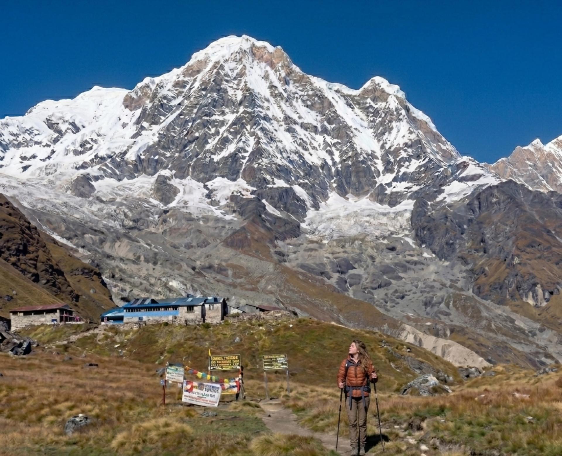 Solo trekker walking toward Annapurna Base Camp with Annapurna mountain towering above, illustrating the challenge and difficulty of the Annapurna Base Camp Trek.
