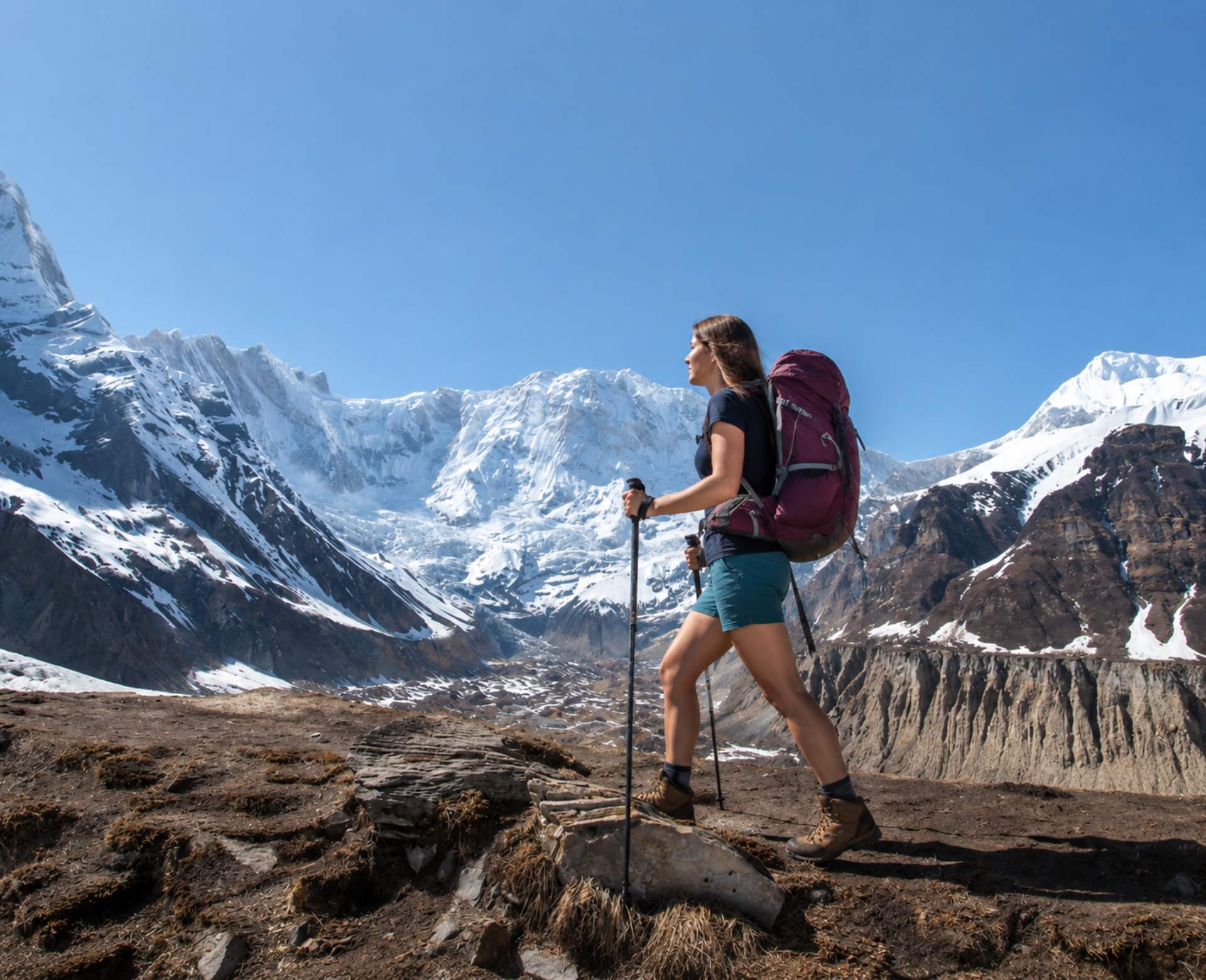 Solo trekker hiking on the Annapurna Base Camp trail with snow-capped Himalayan mountains in the background during an Annapurna Base Camp Trek Without Guide.