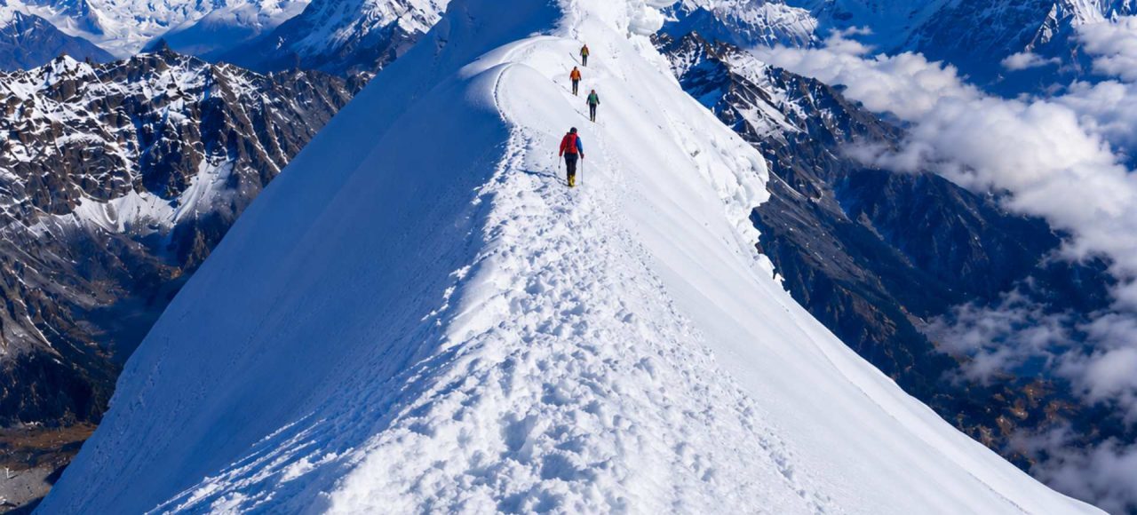 Climbers ascending the snowy ridge of Lobuche Peak during a Lobuche Peak climbing expedition via Everest Base Camp and Kala Patthar in Nepal.