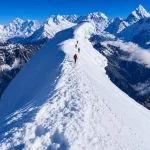 Climbers ascending the snowy ridge of Lobuche Peak during a Lobuche Peak climbing expedition via Everest Base Camp and Kala Patthar in Nepal.