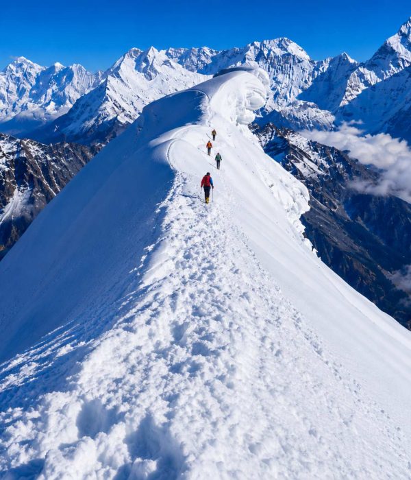 Climbers ascending the snowy ridge of Lobuche Peak during a Lobuche Peak climbing expedition via Everest Base Camp and Kala Patthar in Nepal.