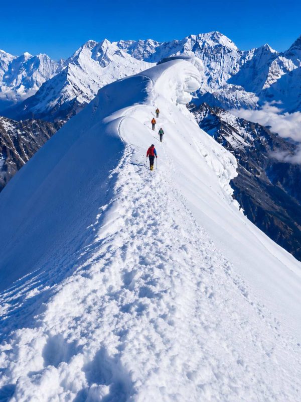 Climbers ascending the snowy ridge of Lobuche Peak during a Lobuche Peak climbing expedition via Everest Base Camp and Kala Patthar in Nepal.