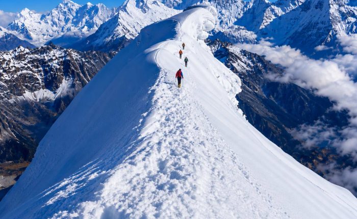 Climbers ascending the snowy ridge of Lobuche Peak during a Lobuche Peak climbing expedition via Everest Base Camp and Kala Patthar in Nepal.