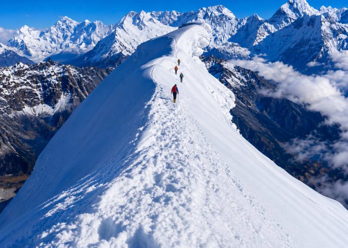 Climbers ascending the snowy ridge of Lobuche Peak during a Lobuche Peak climbing expedition via Everest Base Camp and Kala Patthar in Nepal.