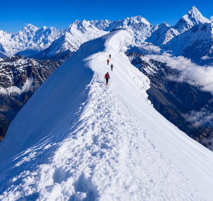 Climbers ascending the snowy ridge of Lobuche Peak during a Lobuche Peak climbing expedition via Everest Base Camp and Kala Patthar in Nepal.