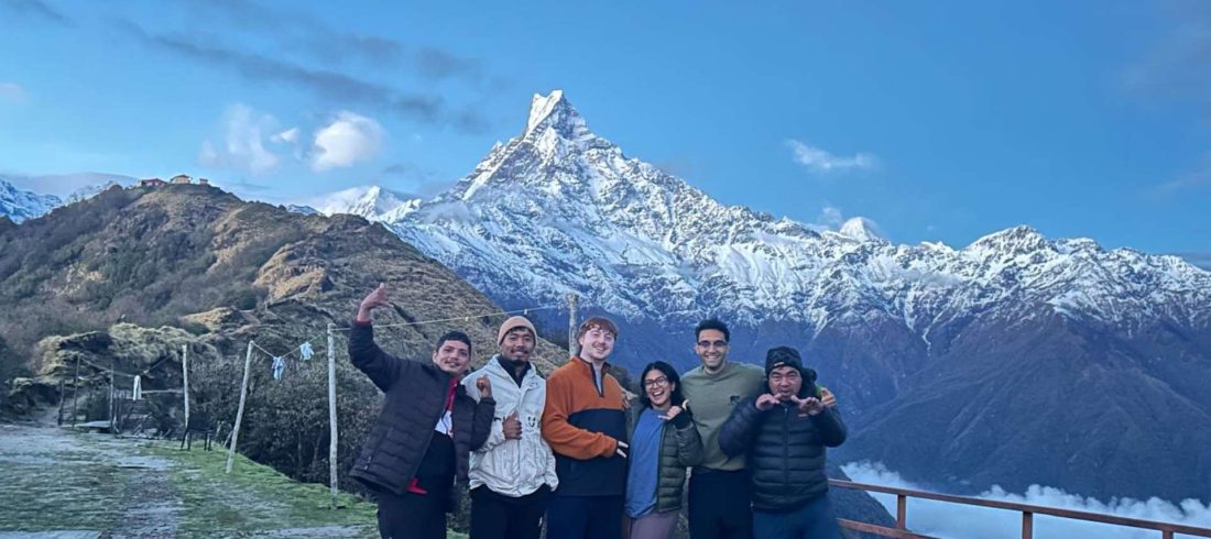 Trekkers posing at Mardi Himal viewpoint with Machhapuchhre mountain during the Mardi Himal Trek in Nepal