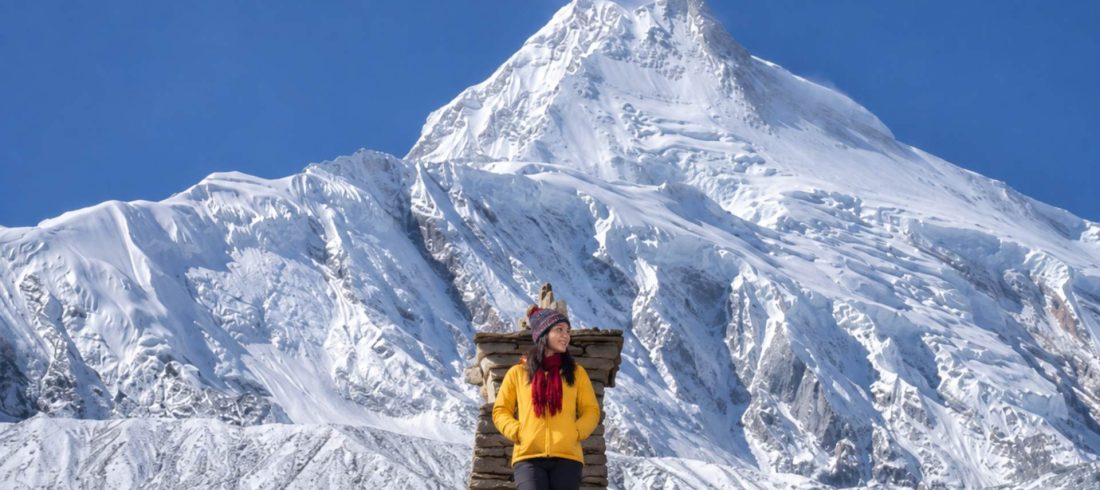 Mountain hiking in Nepal with stunning Manaslu mountain views and snowy Himalayan landscape during trekking adventure