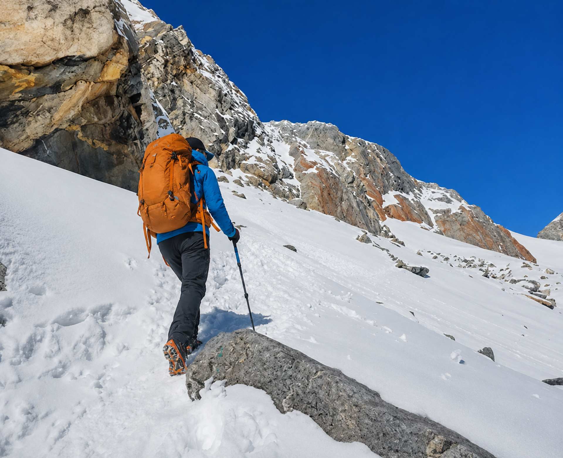 Trekker ascending a steep snowy slope during the challenging Everest Three Passes Trek in Nepal.