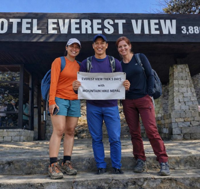 Trekkers posing with Mountain Hike Nepal banner during the Everest View Trek at Hotel Everest View (3,880m) in the Everest region of Nepal.