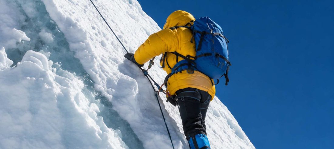 Beginner climber ascending a fixed rope section on Island Peak in Nepal