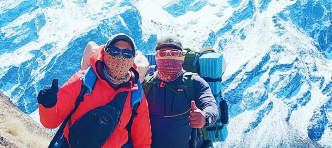 Beginner climbers trekking in the Langtang region during a Yala Peak expedition with Himalayan mountains in the background.