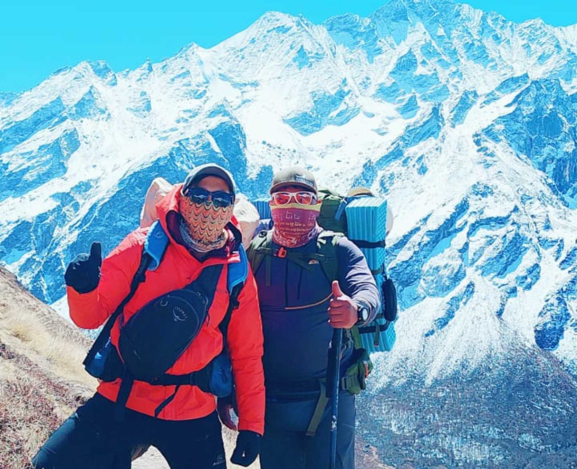 Beginner climbers trekking in the Langtang region during a Yala Peak expedition with Himalayan mountains in the background.