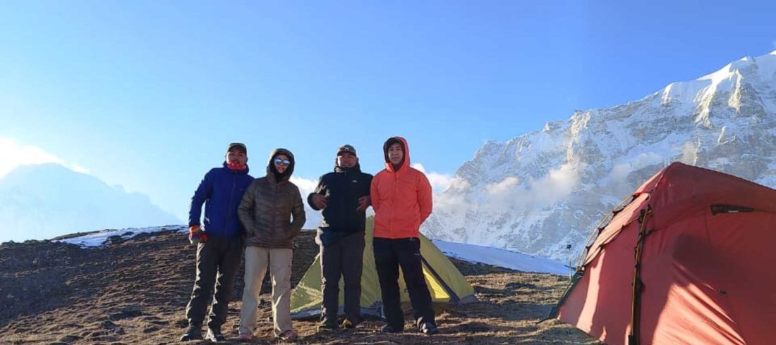 Climbers standing beside tents at Yala Peak High Camp in Langtang, Nepal during a guided climbing expedition.