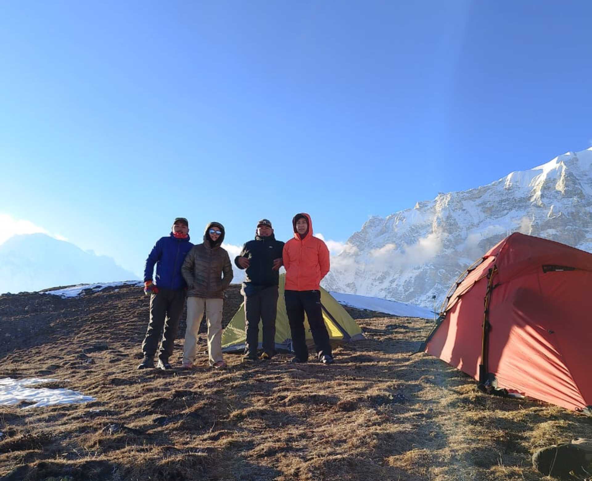 Climbers standing beside tents at Yala Peak High Camp in Langtang, Nepal during a guided climbing expedition.