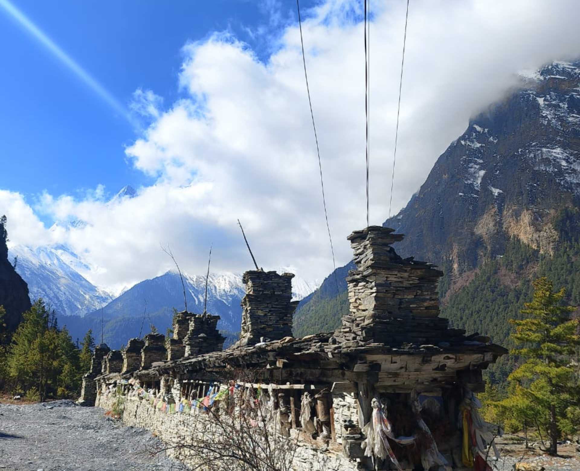 Manang Tour – Traditional Stone Gateway in Nepal Traditional stone gateway with prayer flags on the Manang Tour route in the Annapurna region of Nepal
