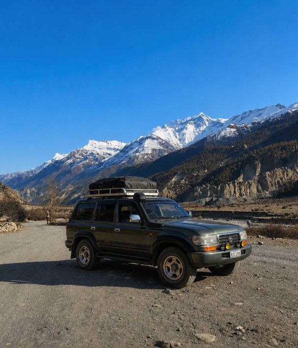 Manang Valley Jeep Tour with a black 4WD jeep on the scenic mountain road in the Annapurna region of Nepal