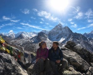 Couple enjoying the breathtaking Himalayan scenery during the Nangkartshang Peak Trek in Nepal's Everest region.