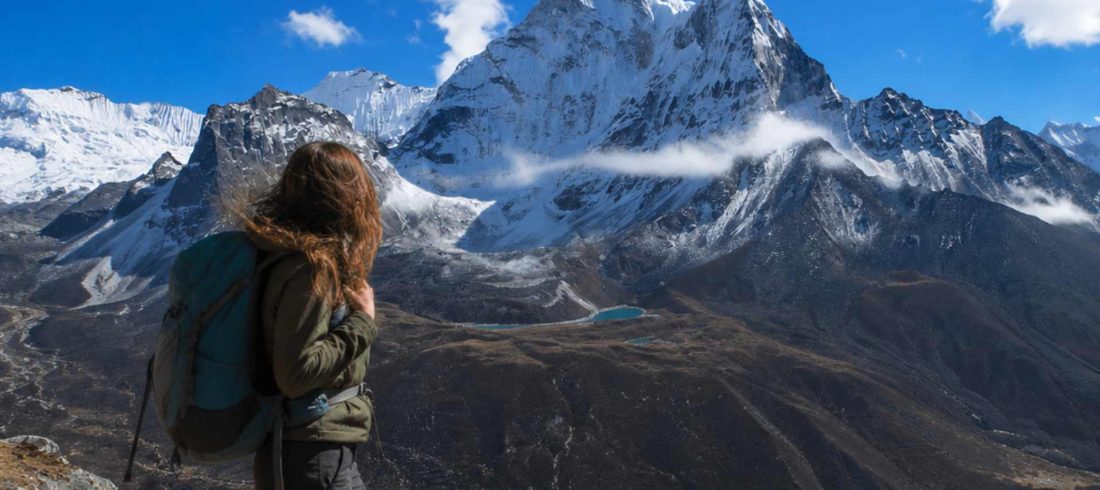 Solo trekker enjoying panoramic Himalayan views during the Nangkartshang Peak Trek in Nepal.