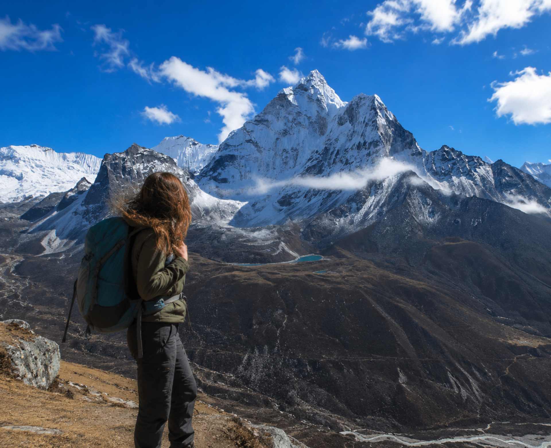 Solo trekker enjoying panoramic Himalayan views during the Nangkartshang Peak Trek in Nepal.