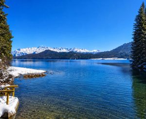 raRara Lake Jeep Tour – Winter Panorama of Rara Lakeara-lake-jeep-tour-winter-view Winter view of Rara Lake during the Rara Lake Jeep Tour with crystal-clear blue water and snow-capped mountains in Nepal