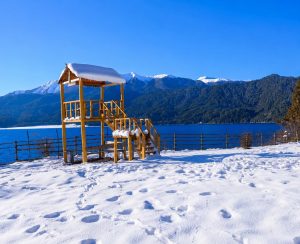 Winter Snow View of Rara Lake, Nepal Snow-covered viewpoint overlooking Rara Lake with pine forests and snow-capped mountains in western Nepal