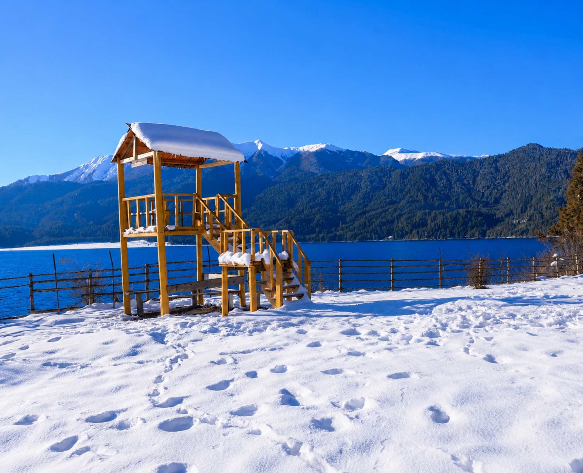 Winter Snow View of Rara Lake, Nepal Snow-covered viewpoint overlooking Rara Lake with pine forests and snow-capped mountains in western Nepal