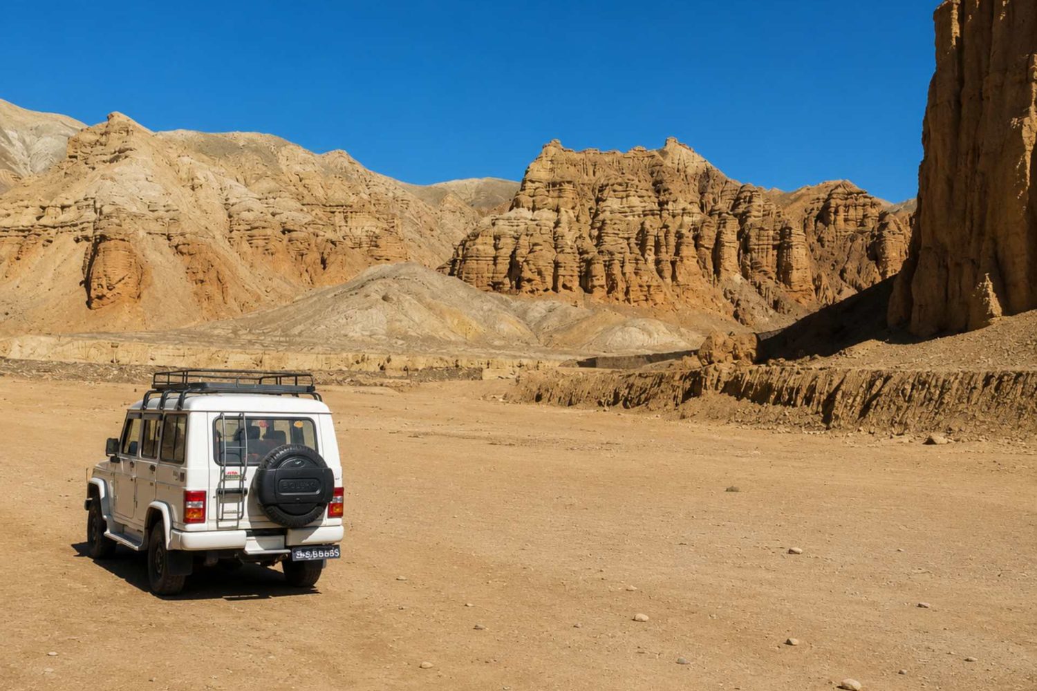 4WD jeep exploring the dramatic desert landscape on the Upper Mustang Overland Tour in Nepal