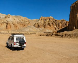 Upper Mustang Overland Tour – 4WD Jeep Adventure in Nepal 4WD jeep exploring the dramatic desert landscape on the Upper Mustang Overland Tour in Nepal